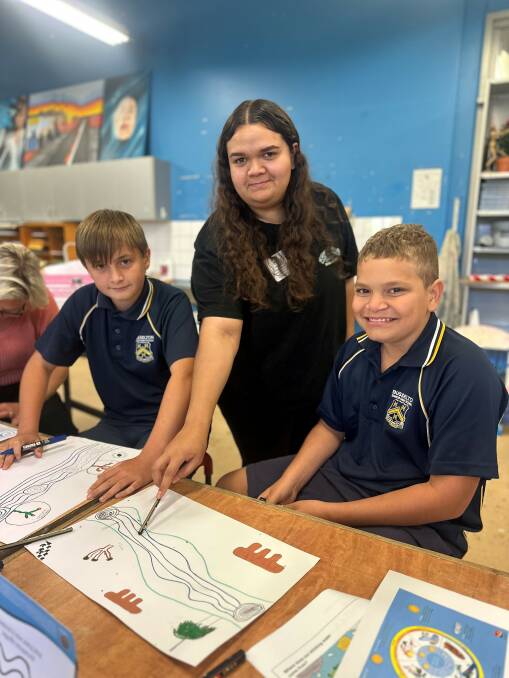 Indigenous artist Mariah Yarran and Busselton High School Waalitj Kaaditjin Academy students Alan Thorne and Darcy Anderson working on the design for a 200m mural on the Vasse Diversion Dam wall.